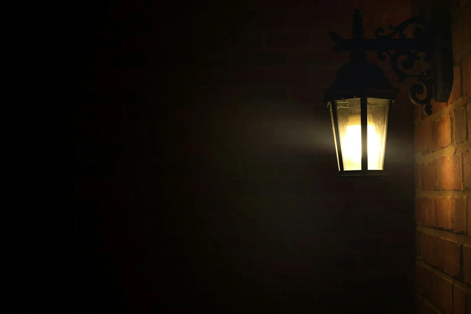Amber night light plugged into a wall socket, warm glow