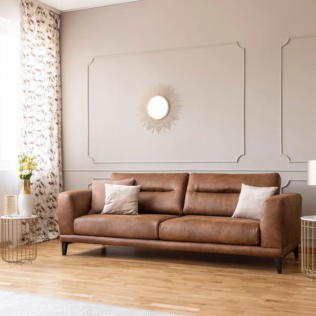 Brown sofa anchoring a warm living room