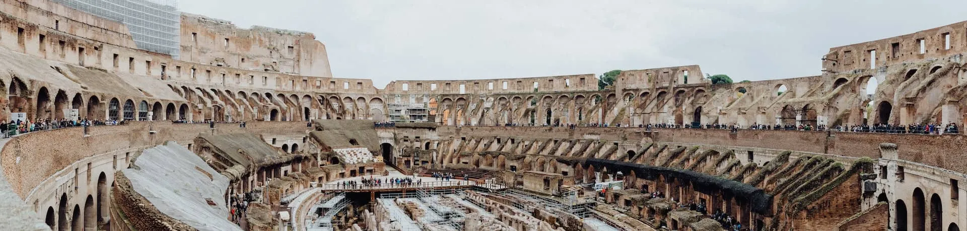 Wide view of the Colosseum against the Roman sky