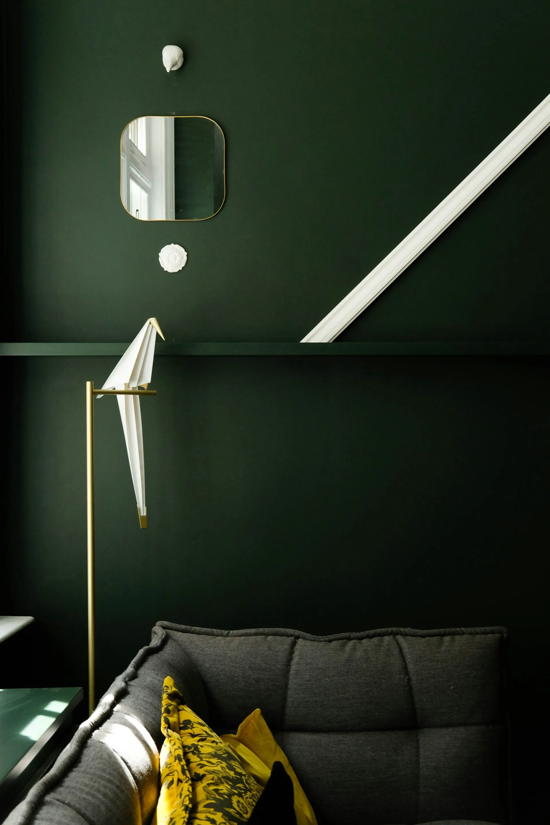 Minimalist modern room featuring muted olive green painted walls