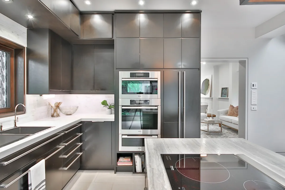Modern kitchen with espresso brown cabinets and marble stone surfaces