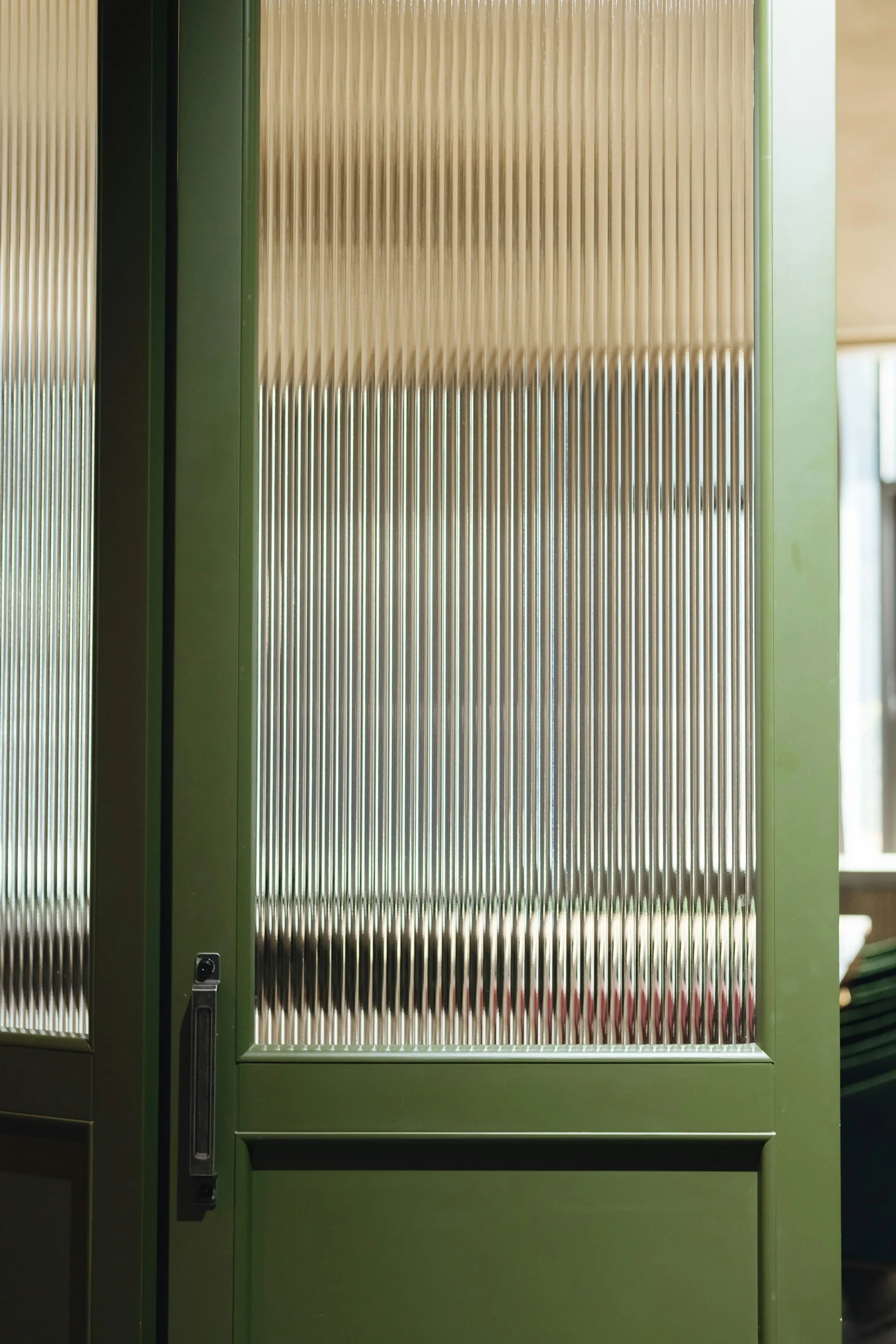 Reeded ribbed glass cabinet door in a modern interior setting