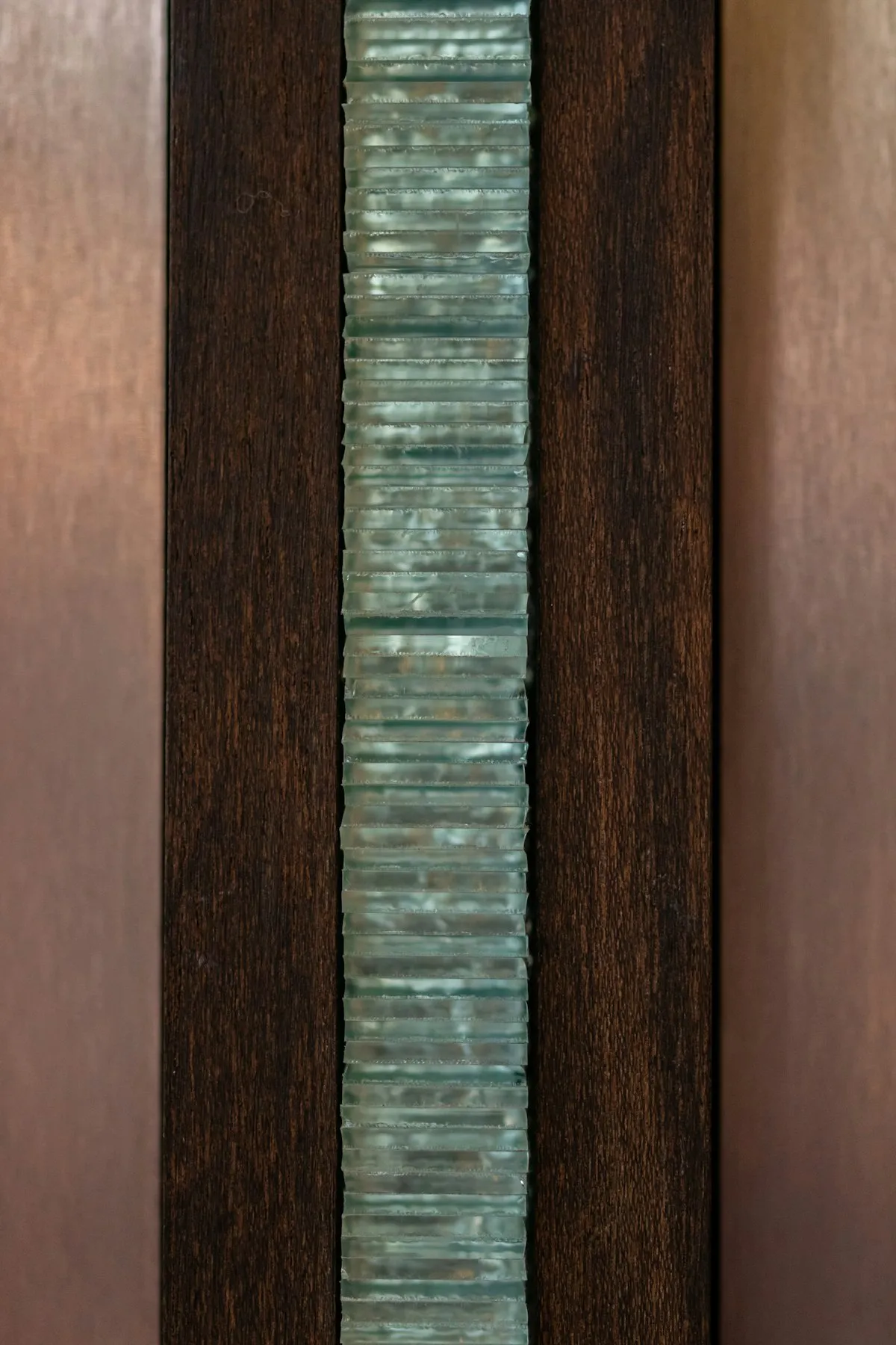 Reeded glass divider with a dark espresso wood frame