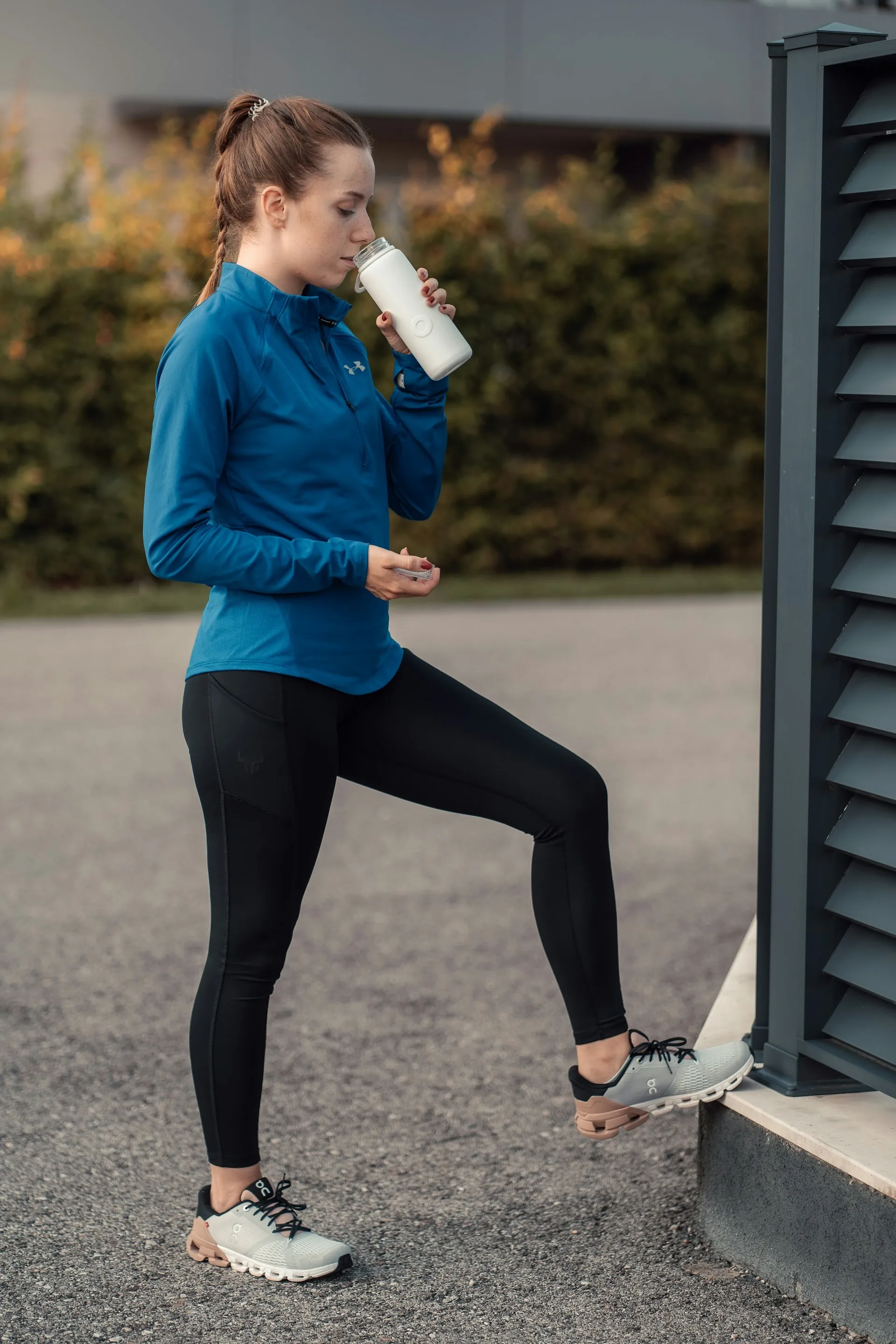 Person drinking from a water bottle after a gym workout